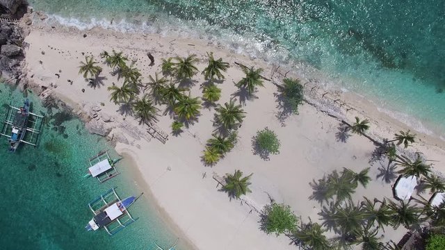 Pacific Island At Sea Level Feels Human Impact From Climate Change, Desert Islet From Static Drone Overhead With Clear Turquoise Waters On The Beach