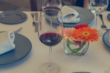Wine glass in restaurant decorated with flowers