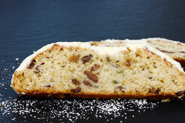 christmas stollen lying on black shale at christmas time