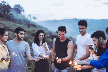 Diversity bestfriend hands holding sparklers and enjoying together at nature,Happy new year concept