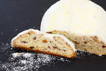 christmas stollen lying on black shale at christmas time