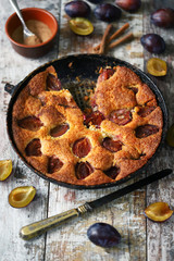 Homemade plum pie. Cooking plum cake. Selective focus. Macro.