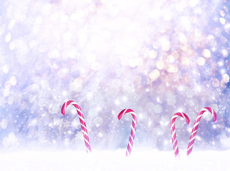 Christmas fabulous card with candy canes lollipops in snowdrift on winter snow background with...