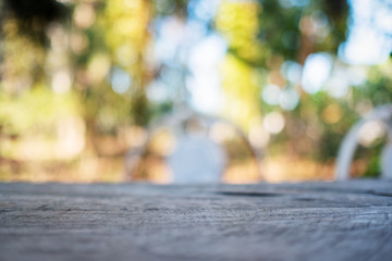 Closeup image of a wooden table with blurred nature in background