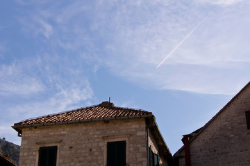 The building in the old town on the background of blue sky. Cator. Old town. Montenegro. - obrazy, fototapety, plakaty