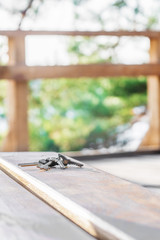 Various keys with ring on a wooden board