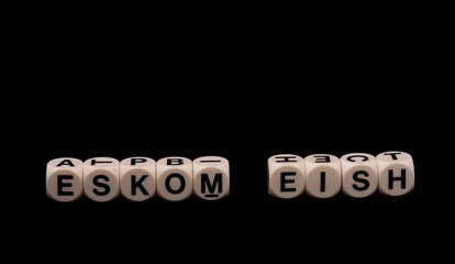 The term Eskom and the South African slang word eish aghast isolated on a black background image in horizontal format with copy space