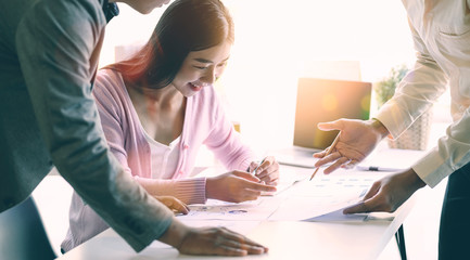 Team of business analysts discussing about business strategy in contemporary office room.