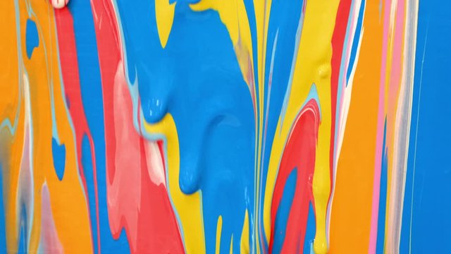colored paint runs down the surface and mixes with other colors