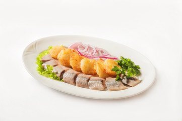 Potato herring close-up. Potato pancakes and herring on a white plate and copy space.