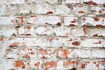 old brick wall with white plaster and red bricks background. vintage brick wall texture