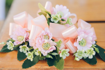 Romantic flower decoration on the table with ribbon.