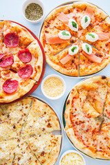 Four types of pizza set background. Top view.
