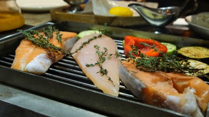Grilled fish, grilled salmon steak, chicken, aromatic spices and grilled vegetables steak, close-up, 4k.