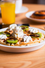 Belgian waffles juice on a wooden table at coffee shop.