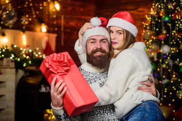 Happy new year. Bearded man and woman. Cheerful mood. Couple in love enjoy christmas holiday celebration. Christmas time. Lovely married couple cuddle christmas tree background. Happiness concept