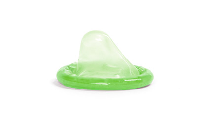 Green condom, isolated
