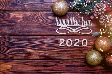 Happy new year 2020 on wooden brown background.