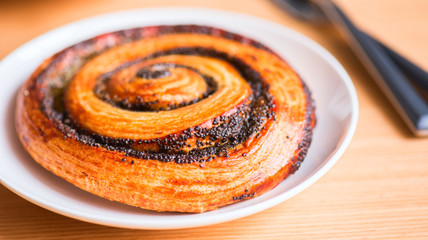 Poppy seed danish pastry roll in a plate.