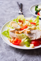 Salad with grilled chicken, vegetable and eggs.