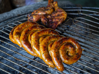 Northern Thailand style Grilled Thai sausage and Chicken thigh leg by charcoal stove
