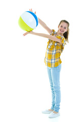 Fototapeta premium Little girl is playing with a ball.The concept of children's spo