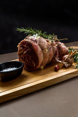 Raw rolled and tied Herdwick Sheep lamb joint prepared with garlic, rosemary and sea salt.
