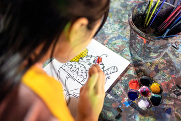 Asian child girl studying and learning the art,happy schoolgirl with palette and paintbrush to painting watercolor on canvas,drawing,painting a picture,hobby,activity,concept art, creativity,education