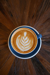 Cup of coffee latte art with coffee shop.