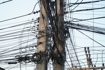 Chaos of cables and wires on an electric pole.