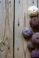 yarn balls  on wooden background. a wooden background with yarn balls with copy space for design stylish