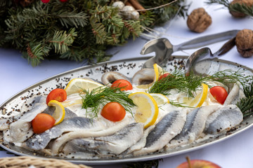 Fototapeta na wymiar Marinated herring fillets in a cream sauce on a plate