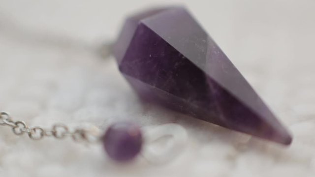 Macro rack focus of an Amethyst pendulum.