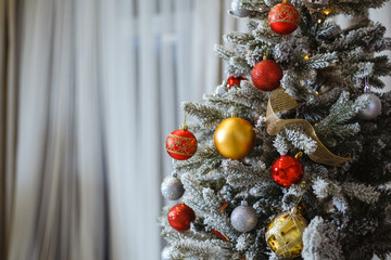 Christmas tree decorated with red and gold toys.