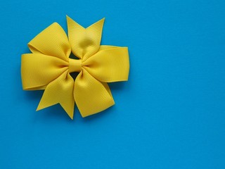 Yellow bow isolated on blue background