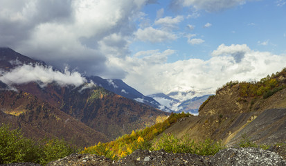 Mountain  slopes covered with forests and low thunderclouds in Svaneti in the mountainous part of...