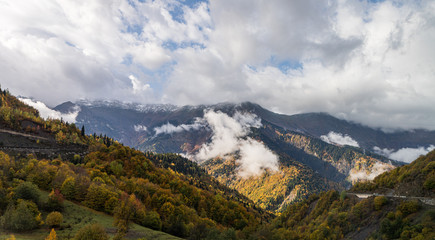 Mountain  slopes covered with forests and low thunderclouds in Svaneti in the mountainous part of Georgia