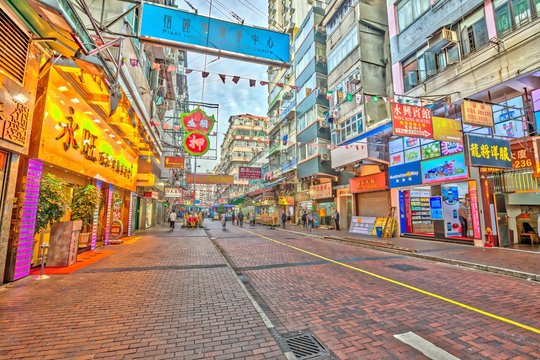 Hong Kong, China - December 5, 2016: Temple Street near Nathan Road, Yau Ma Tei, Kowloon, at twilight. Temple Street Night Market is a popular street bazaar and famous tourist attraction in Hong Kong.