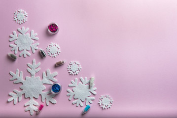 Christmas or winter composition. Pattern made of snowflakes on pastel pink background.