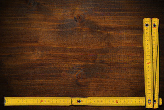 Yellow Measuring Stick On An Old Wooden Table Stock Photo, Picture and  Royalty Free Image. Image 95559225.