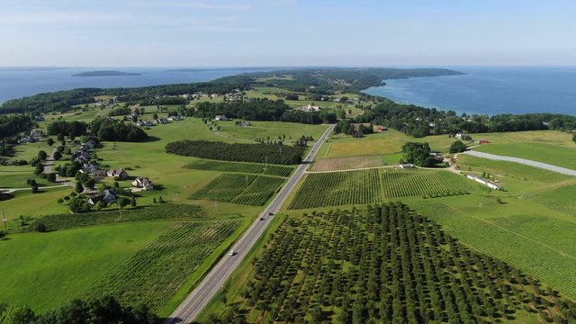 Vineyard tours Wine Tasting in Summer Grape vines Travel Trip Vacation Michigan Sky Clouds Orchard Farm House Farming Colors in Pure Michigan drone fling over Lake Michigan Old Mission Peninsula