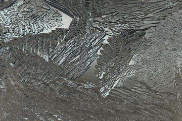 Ice on a window glass in winter. Mystical abstract pattern. Crystals of frozen water close-up. Weather forecast: cooling. Dark background or wallpaper. The picture is monochrome, slightly greenish.