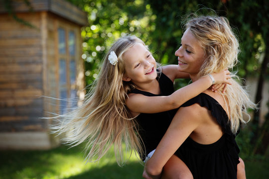 Mother spinning with daughter in her arms