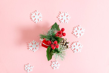 a sprig of Holly on pink background