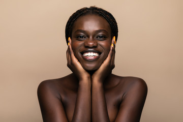 Young african girl with perfect skin on beige background. Beauty Skin care concept - obrazy, fototapety, plakaty