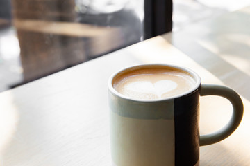 Hot coffee art latte on wooden table