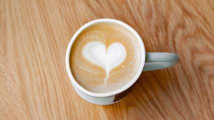 Hot coffee art latte on wooden table