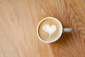 Hot coffee art latte on wooden table