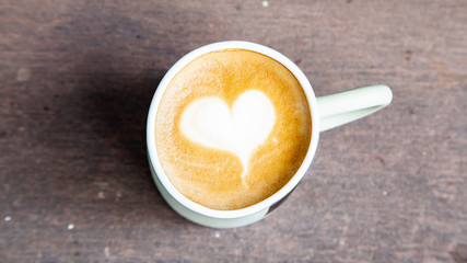 Hot coffee art latte on wooden table