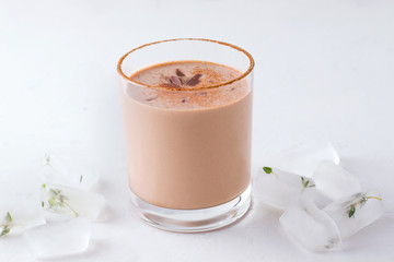 Lassi chocolate indian traditional drink next to ice cubes